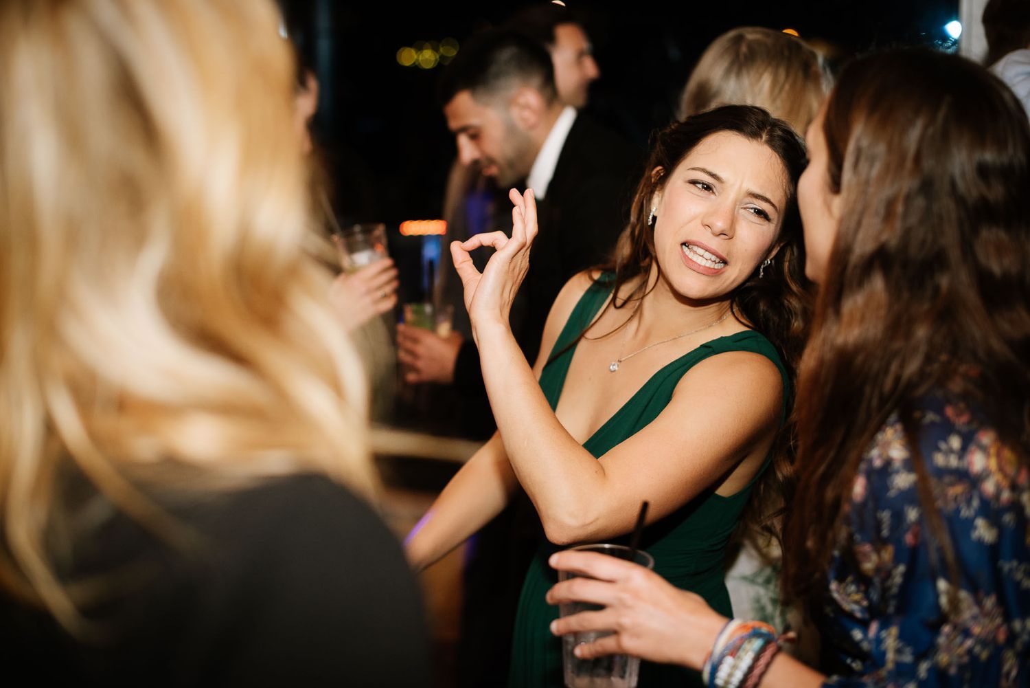 People dancing and laughing together at a lively evening celebration.