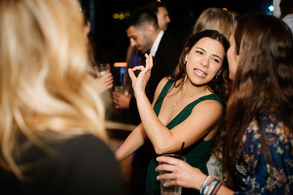 People dancing and laughing together at a lively evening celebration.