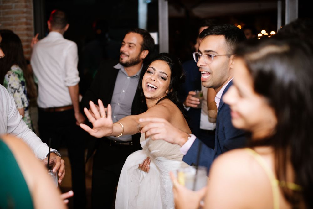 Excited guests celebrating and dancing at a formal evening event.