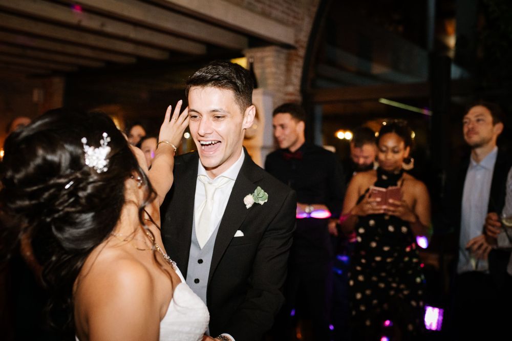 Wedding couple shares a joyful moment during their reception dance.