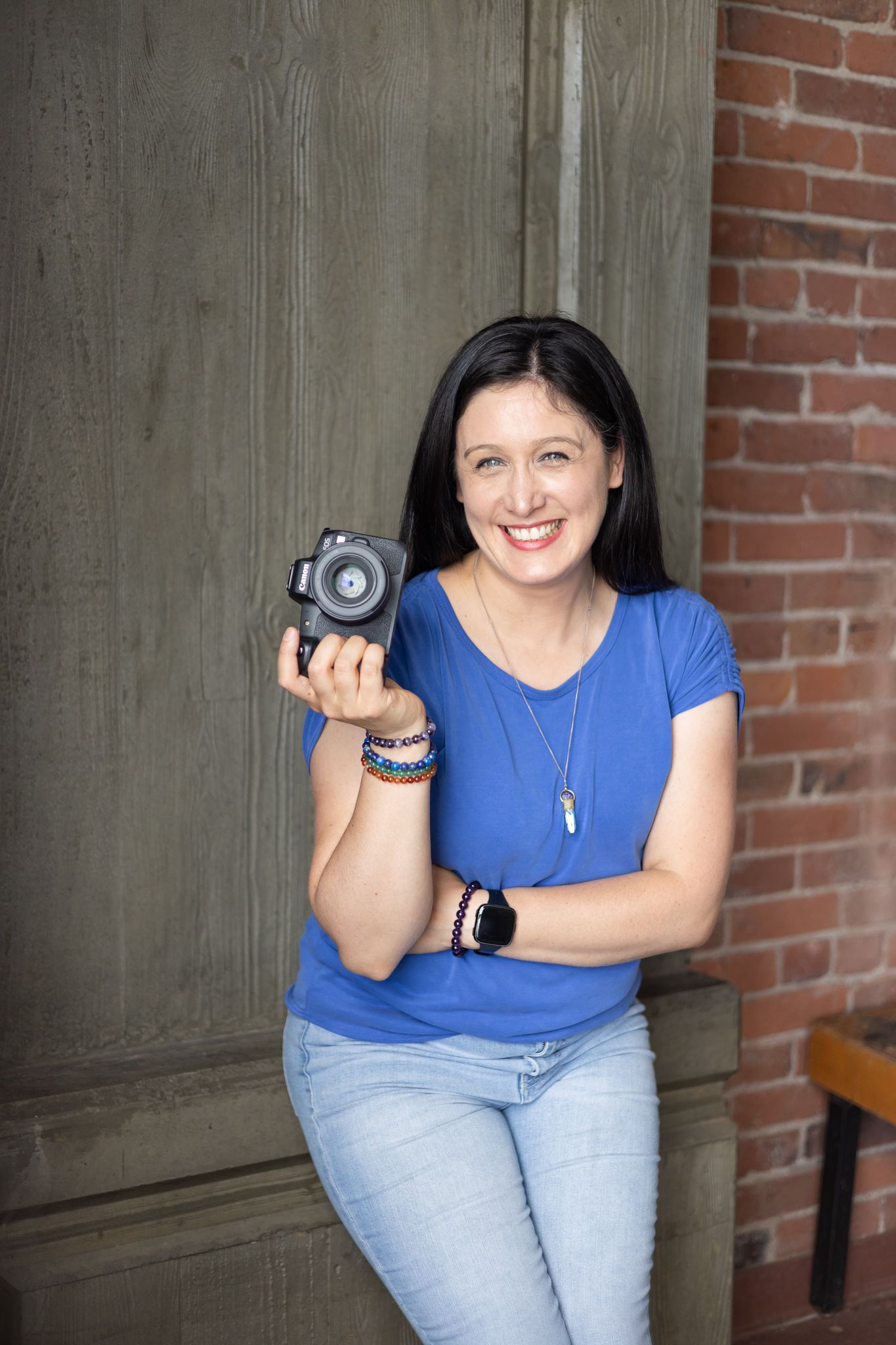 Seattle to Tacoma Personal branding photographer for small business owners smiling holding camera in studio loft