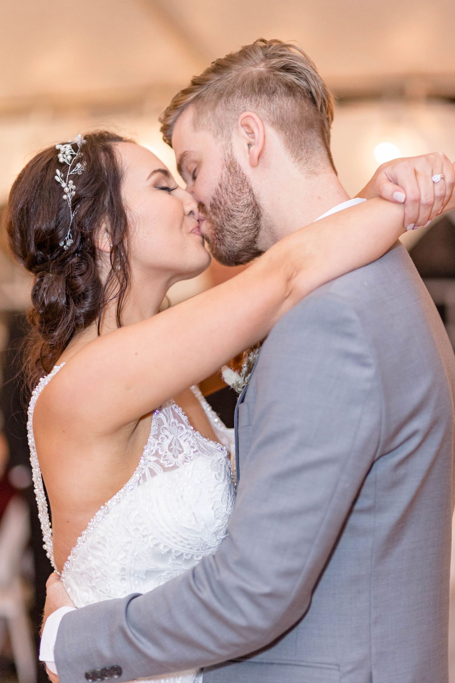 bride and groom kiss during first dance