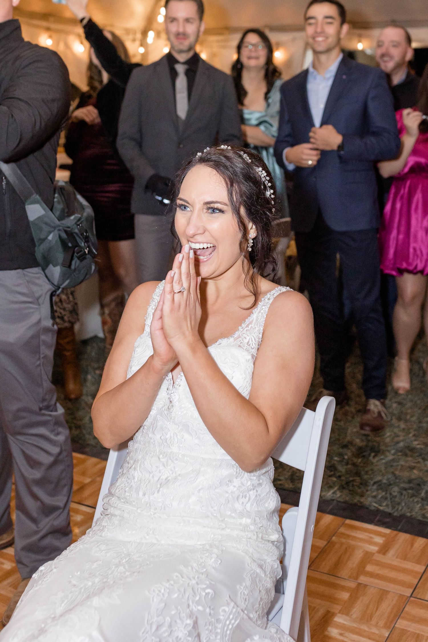 bride laughs before garter toss