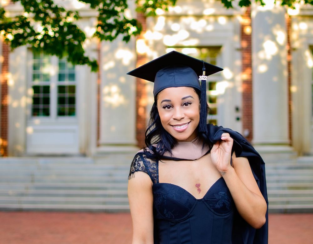 Female graduate with cap holding gown at davidson college
