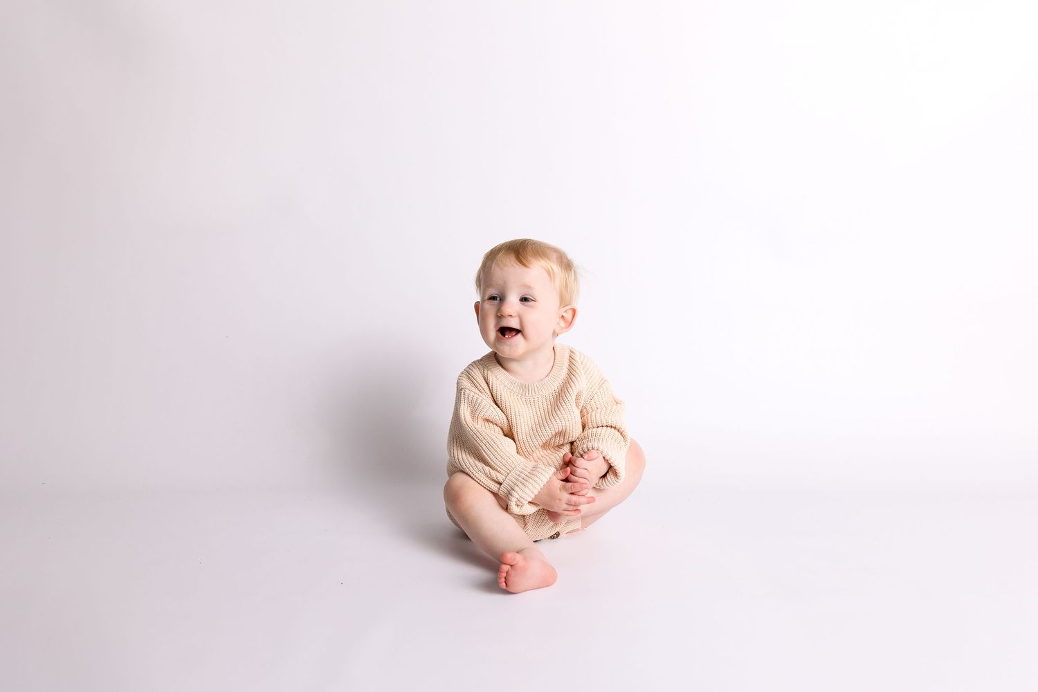 Simple white studio cake smash photography session.