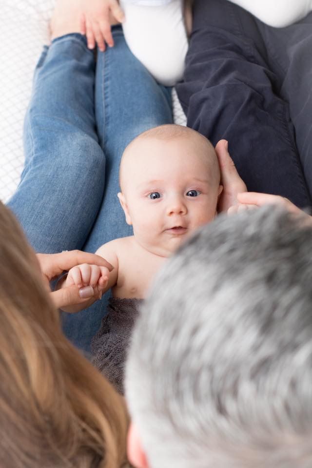 Newborn baby as viewed between parents heads from above.  Louisville Colorado newborn Photographer