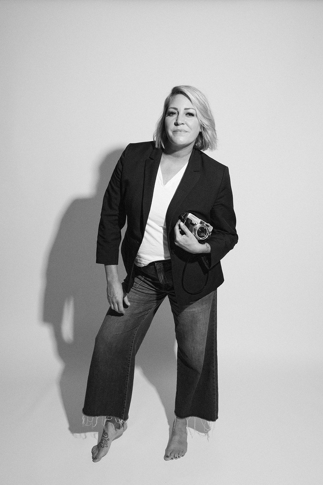 Candid studio shots showing playful poses in business casual attire.