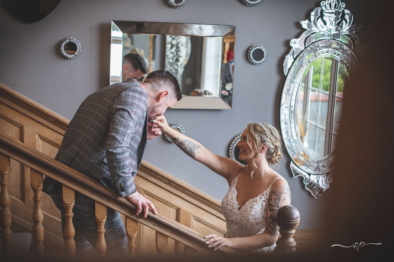 Couples' moments alone, groom kissing bride on the staircase, beautiful wedding photography.