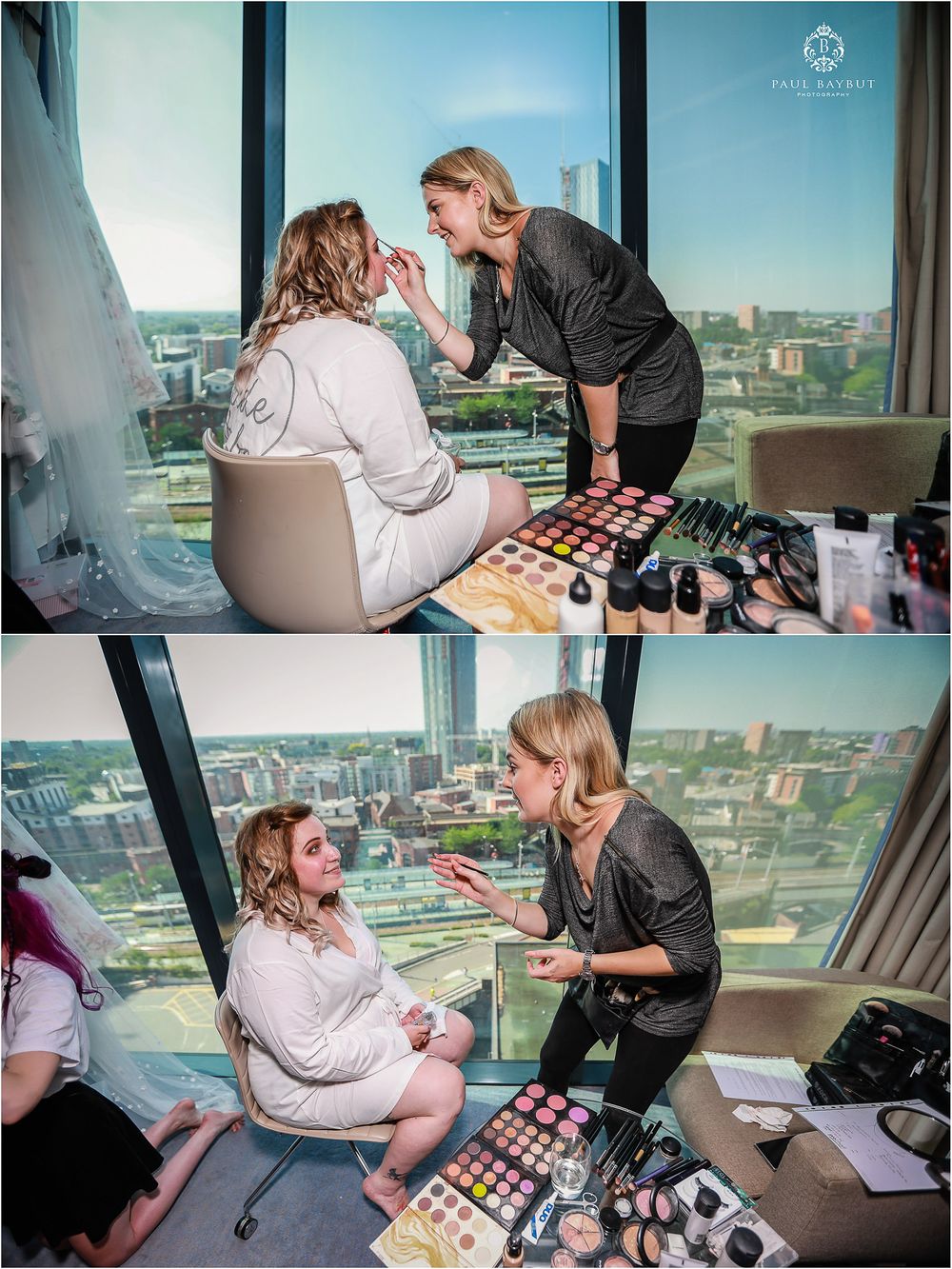 Makeup artist applying cosmetics in high-rise hotel room with city view.