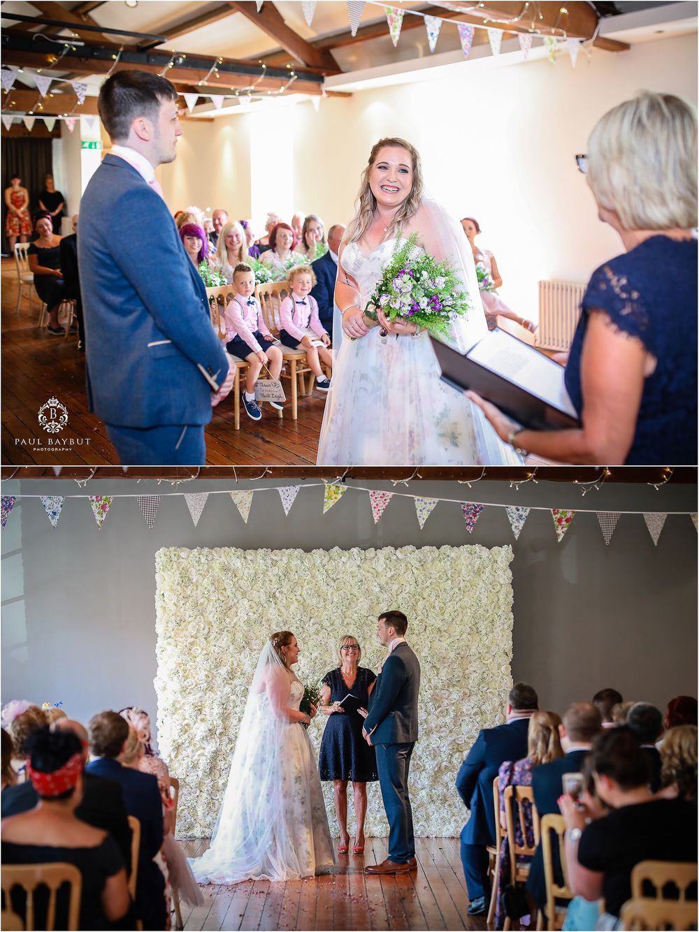 Indoor wedding ceremony with floral backdrop and bunting decorations in rustic venue.