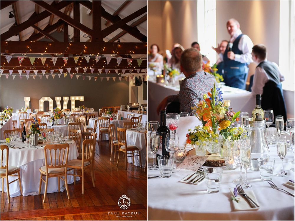 Wedding reception venue decorated with LOVE sign and elegant table settings.