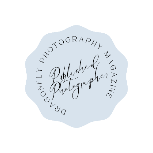 A circular blue and white badge design with text reading 'Published Photographer' in elegant script.