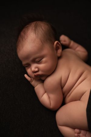 Newborn curled up with baby rolls- Peublo, Colorado Newborn Photographer
