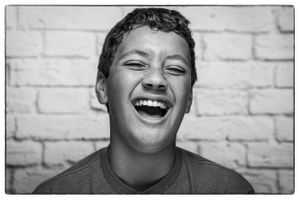 headshot of boy laughing