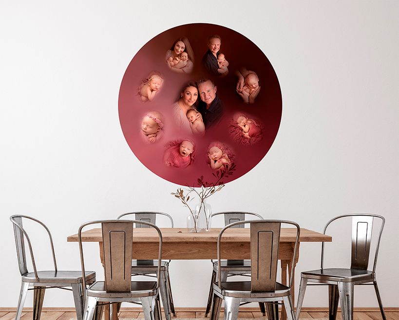 Circular red wall art installation with portrait photographs arranged in a circle above a wooden dining table and metal chairs.