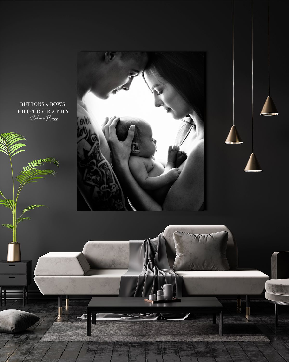 Dramatic black and white family portrait displayed in modern living room with pendant lights.