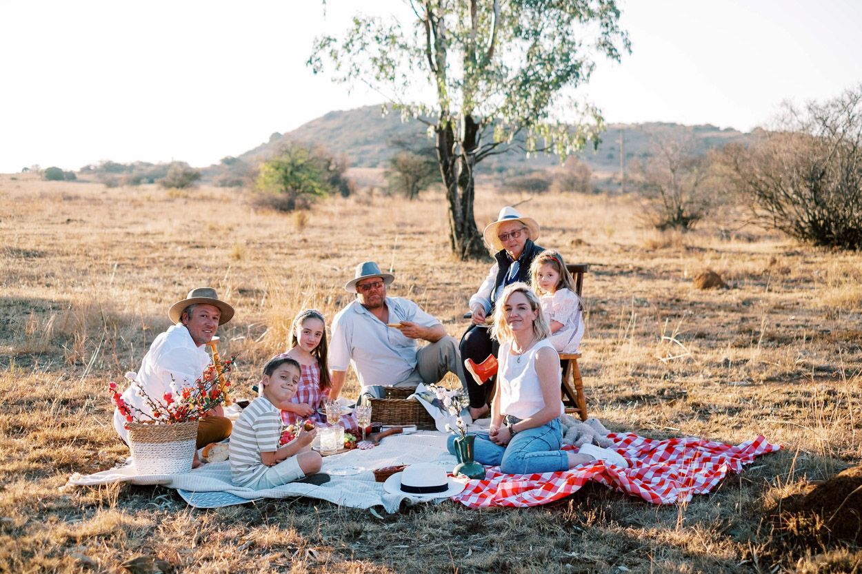 Family enjoys a picnic at sunset on their farm, near Heidelberg, Gauteng