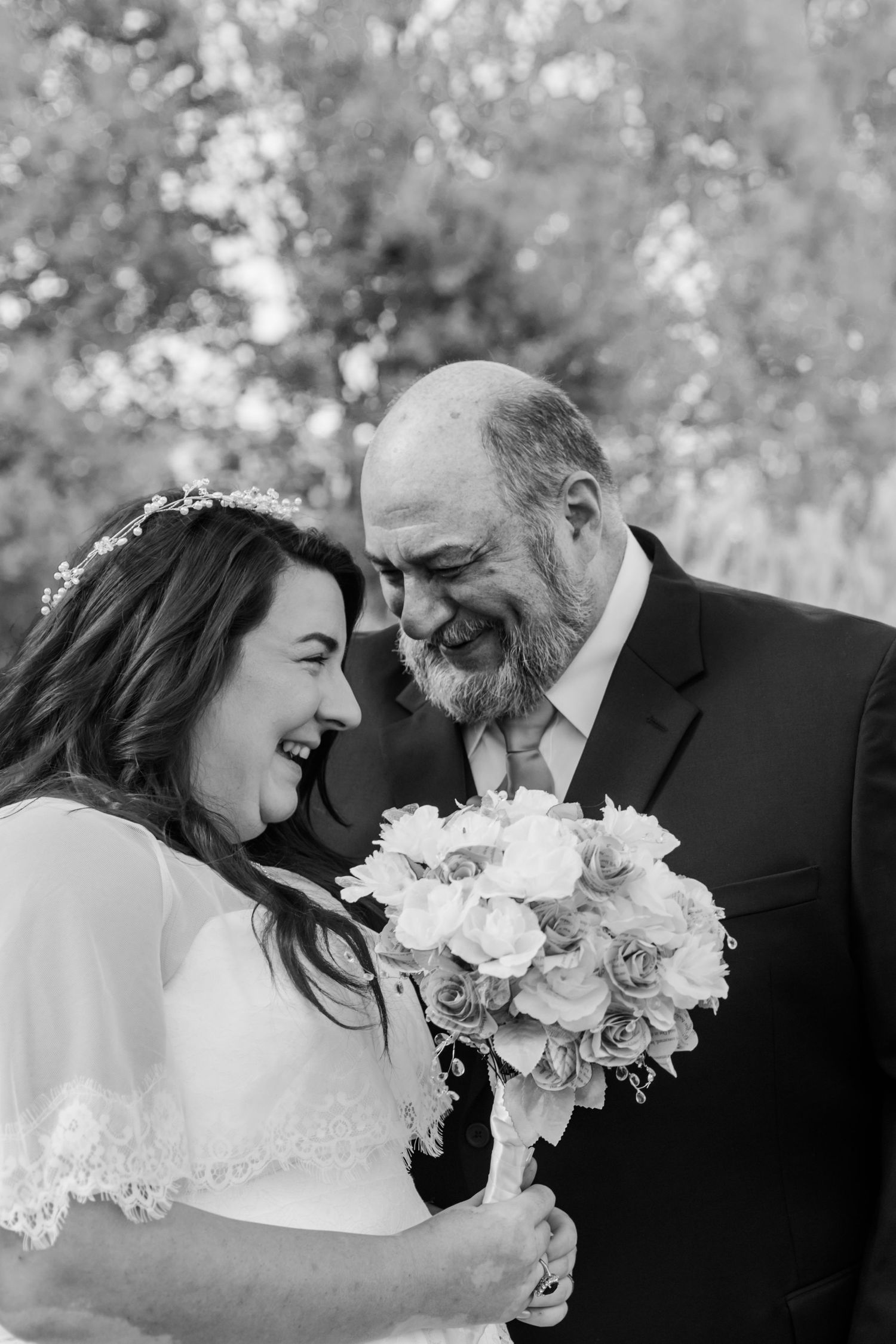 Black and white wedding portrait with delicate white flowers and intimate poses.