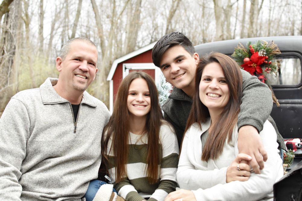 Family of 4 with vintage pickup truck at Christmas, senior portraits