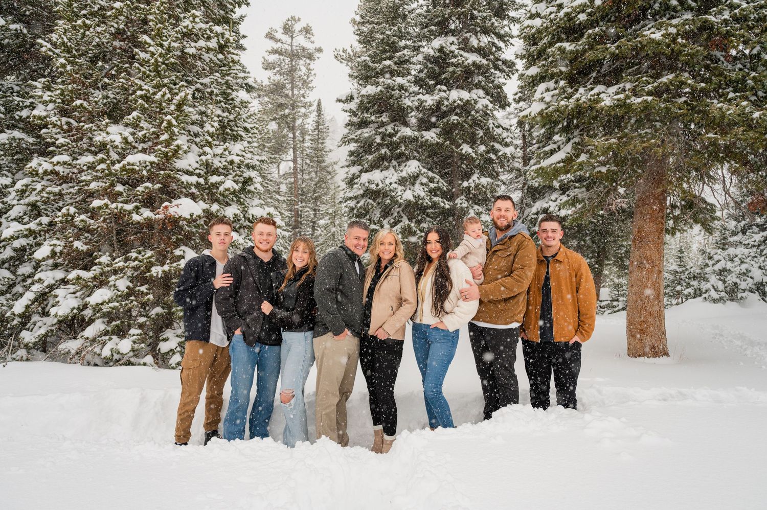Group photo of people standing together in a snowy forest setting.