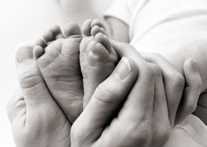 parents hold baby's feet to show how small they are