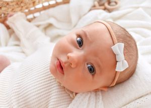 alert baby looks up at the camera during her newborn photos Victoria BC