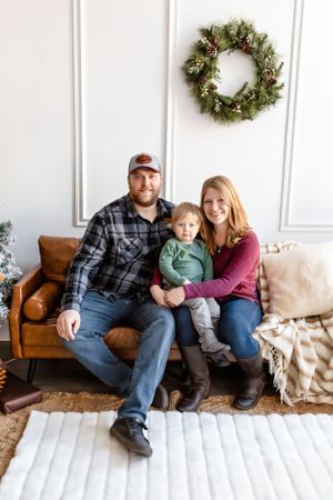 A cozy living room decorated for winter holidays with a festive wreath on the wall above a brown leather couch. Janesville, WI
Brodhead, WI