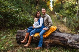 Couple sitting together on fallen log in autumn forest with orange blanket.
Janesville, WI
Brodhead, WI