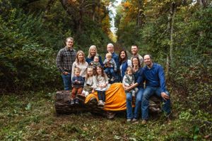 Large group gathered on a fallen log for outdoor family photos in autumn forest setting.
Janesville, WI
Brodhead, WI