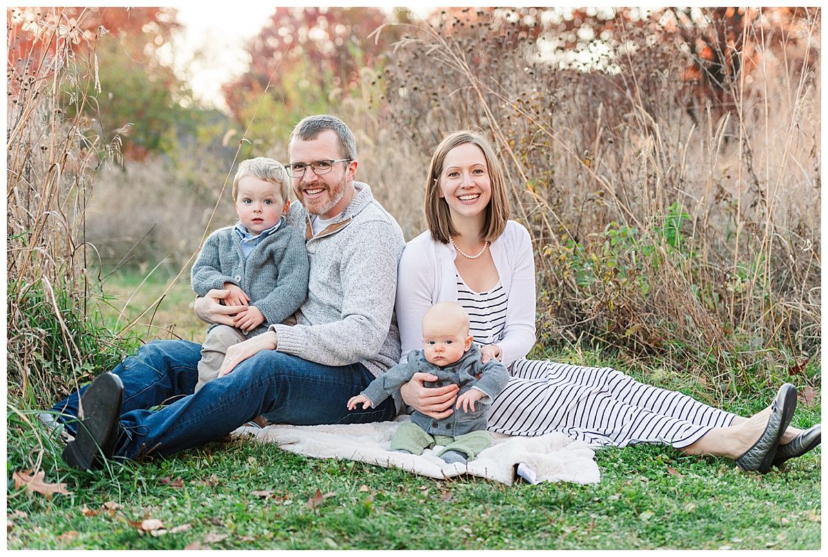 Traditional seated family portrait with young boys during fall in Starkey Park Zionsville Indiana