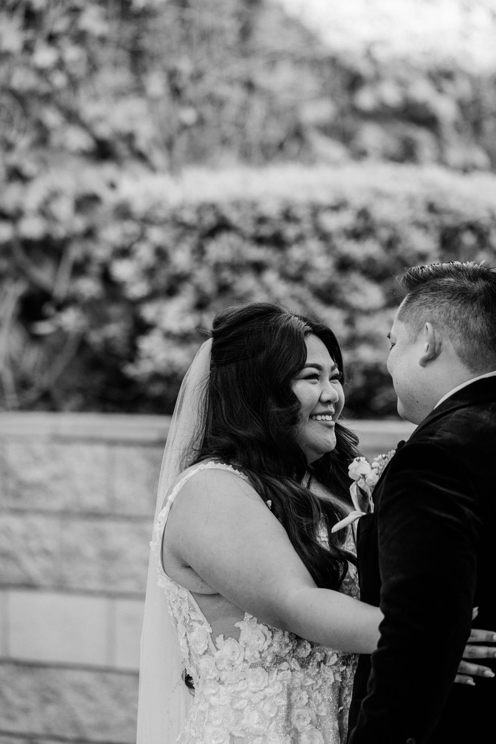 Black and white photo sequence of a couple sharing romantic moments in their wedding attire.