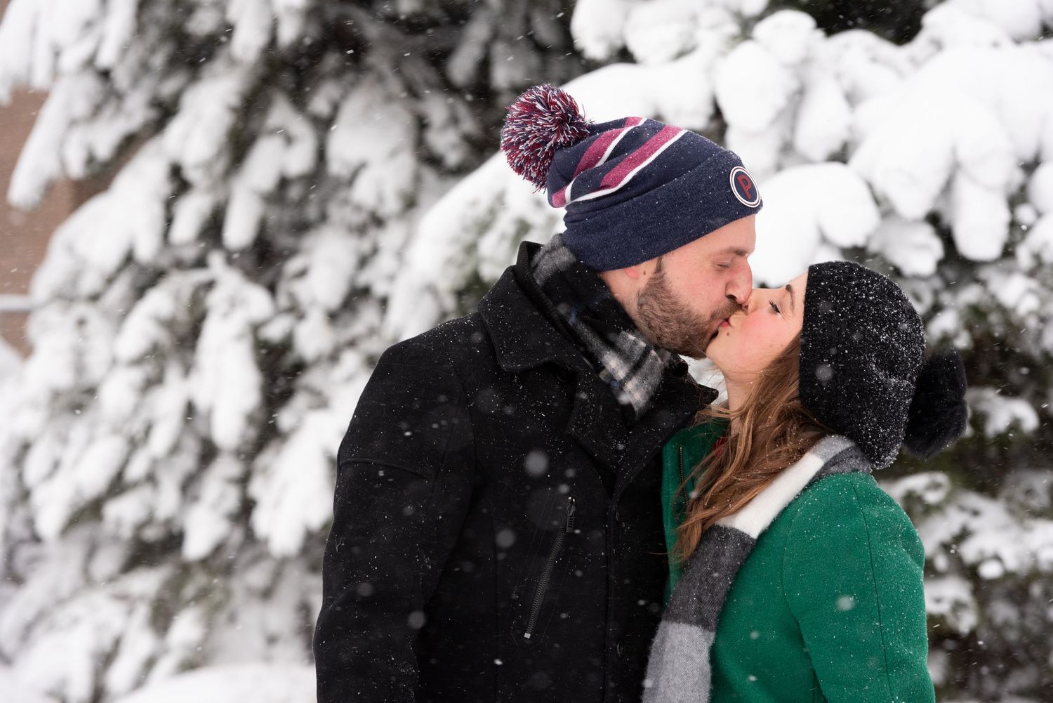 In a blizzard of 2020 this engaged couple kisses in a snowy East Boston winter wonderland with Leah Ramuglia Photography