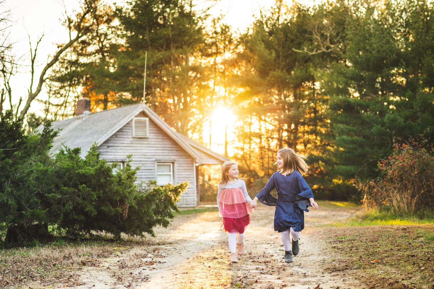SISTERS RUNNING IN A OLD VILLAGE