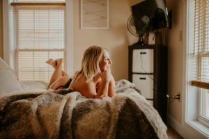 Artistic bedroom photoshoot with warm lighting and minimalist decor.