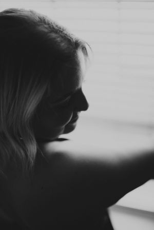 Black and white profile silhouette in natural window light.