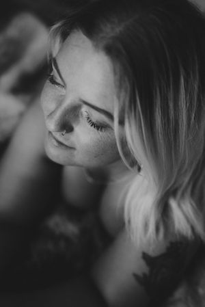 Artistic black and white close-up portrait showing soft lighting and natural expressions.
