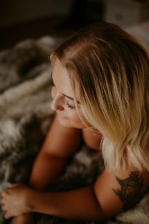 Intimate portrait with soft warm lighting highlighting blonde hair and natural expressions.