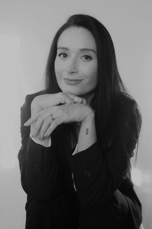 Black and white professional headshot showing elegant business styling.