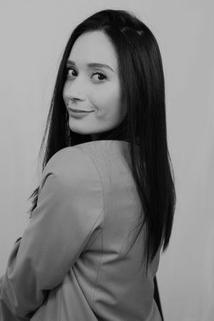 Black and white portrait series showing playful poses in business attire.
