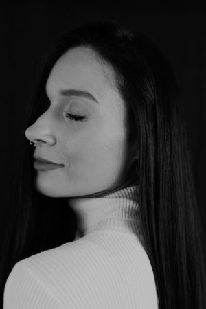 Black and white profile portrait showcasing elegant minimal styling.