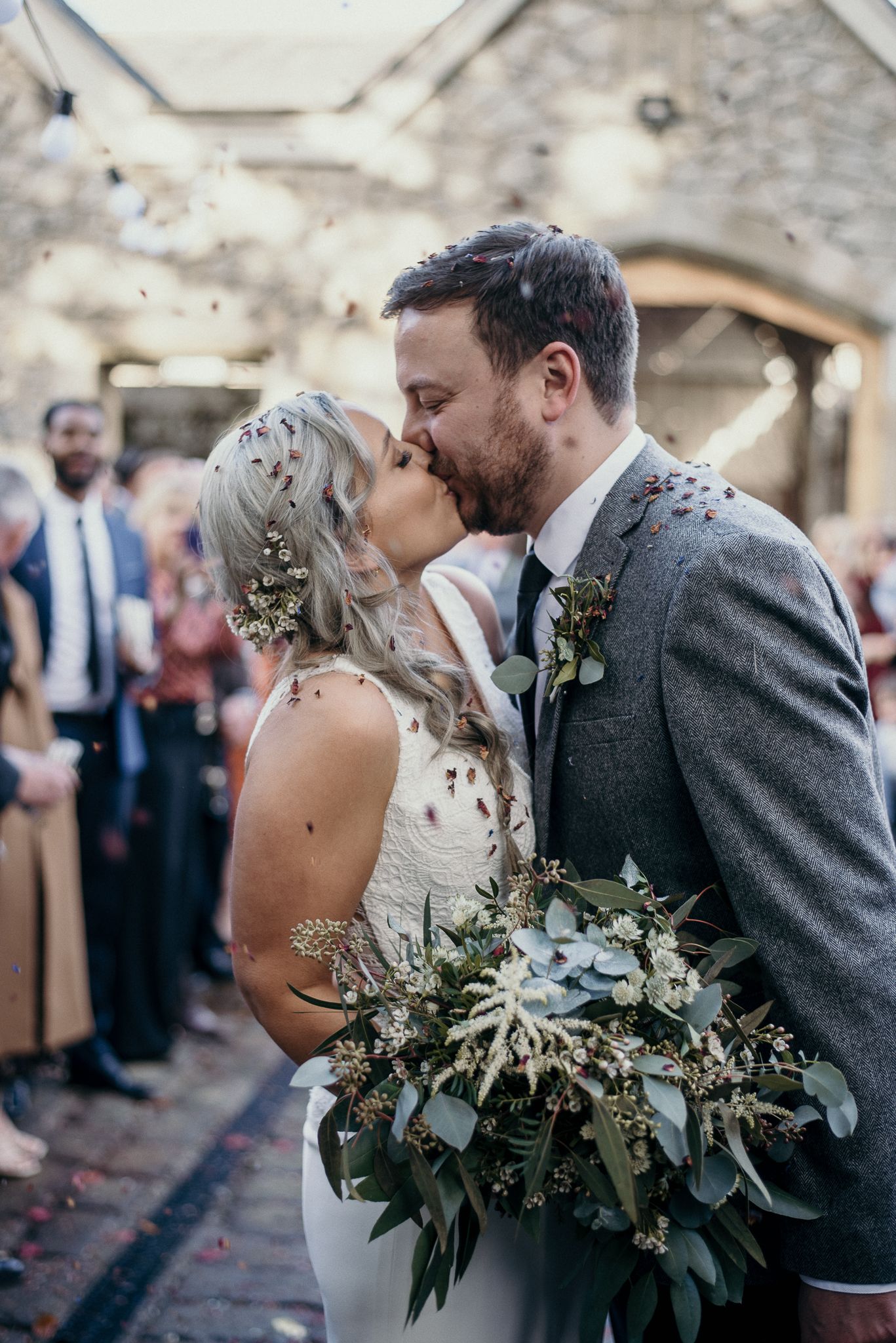 Bride and groom kiss during confetti shot at Wyresdale park wedding venue