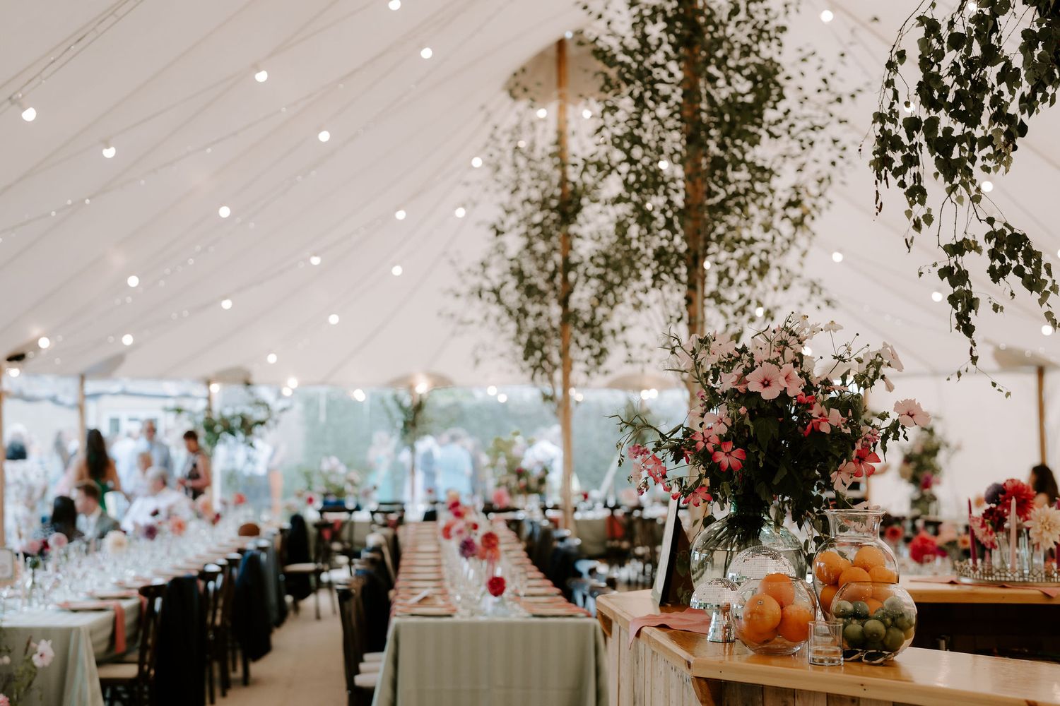 floral arrangements on bar with marquee backdrop  in islip in Oxfordshire