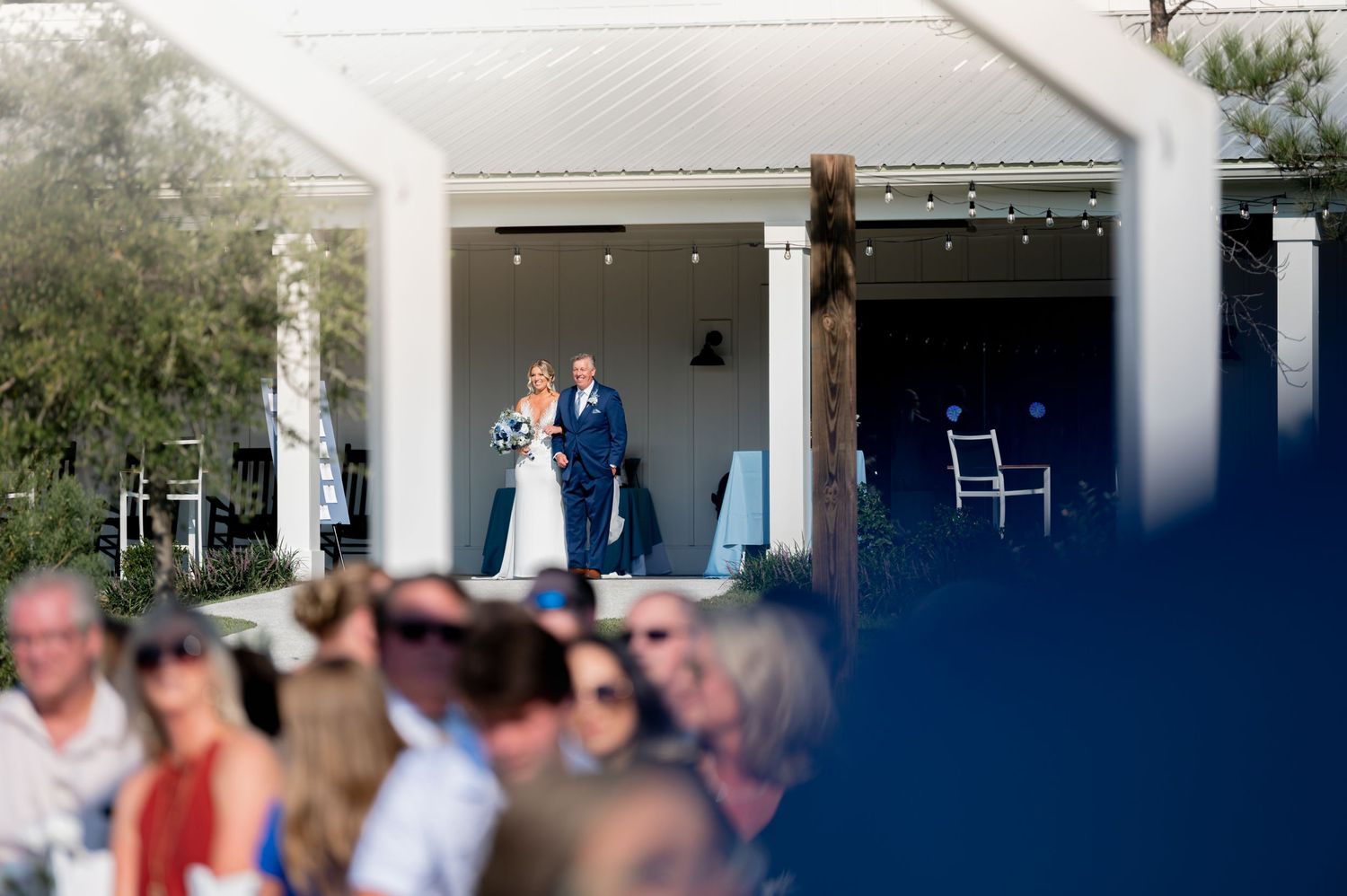Wedding reception venue with white columns and indoor lighting setup.