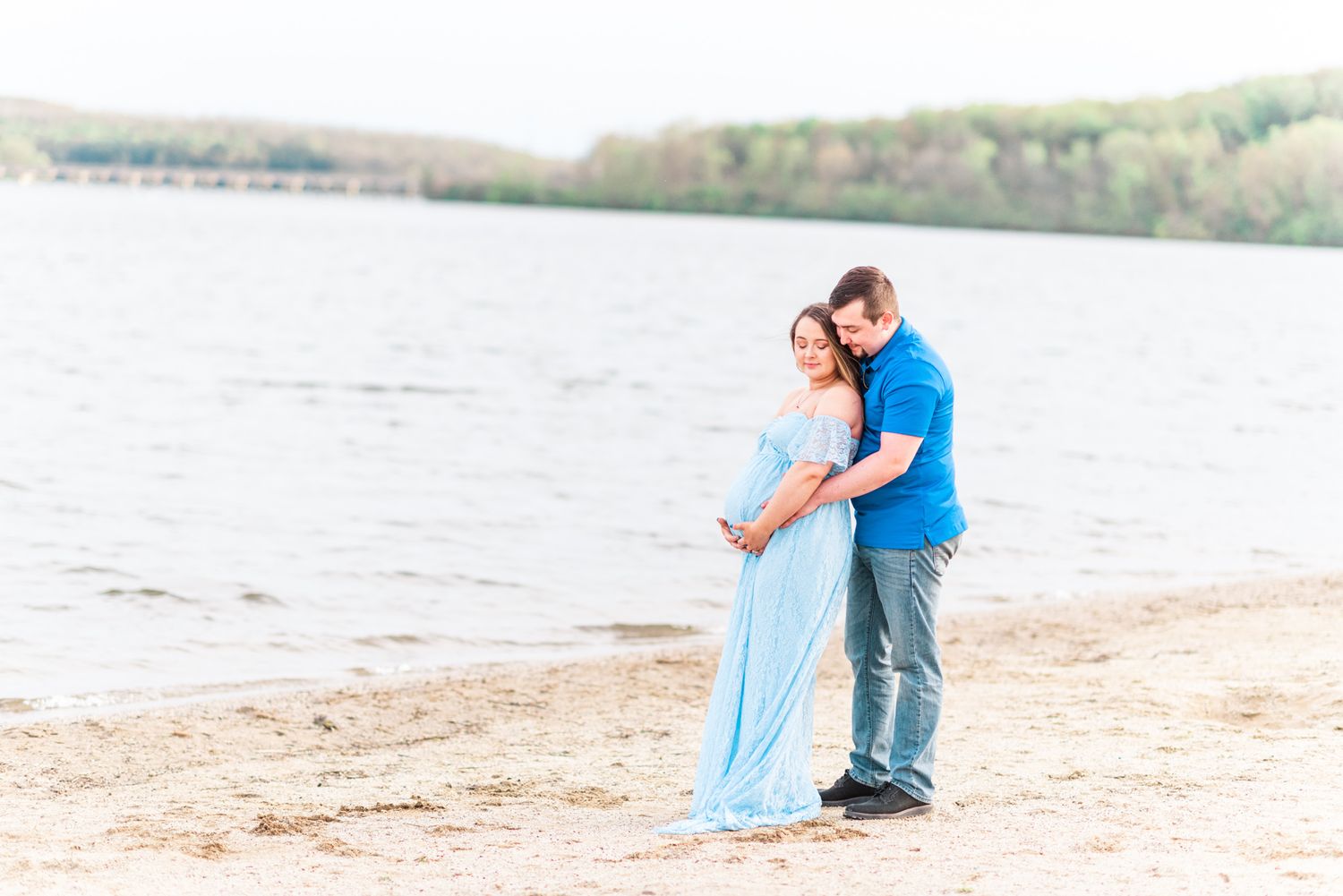 Maternity session with couple on beach in golden hour sunlight at Moraine State Park, Pennsylvania