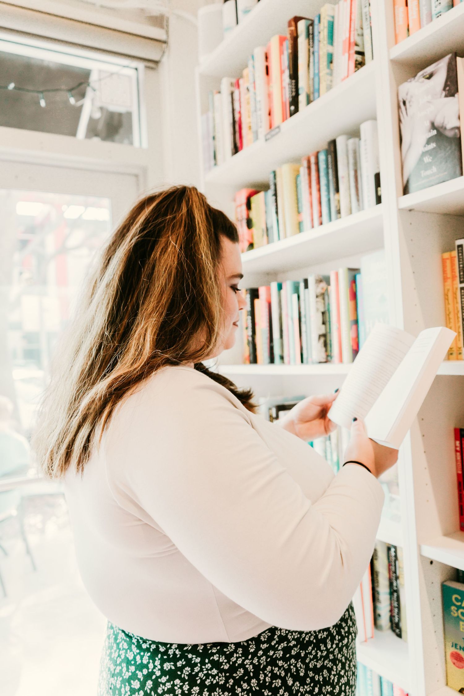 Outdoor Headshot Session in St. Pete, FL; Woman reading a book in a bookshop