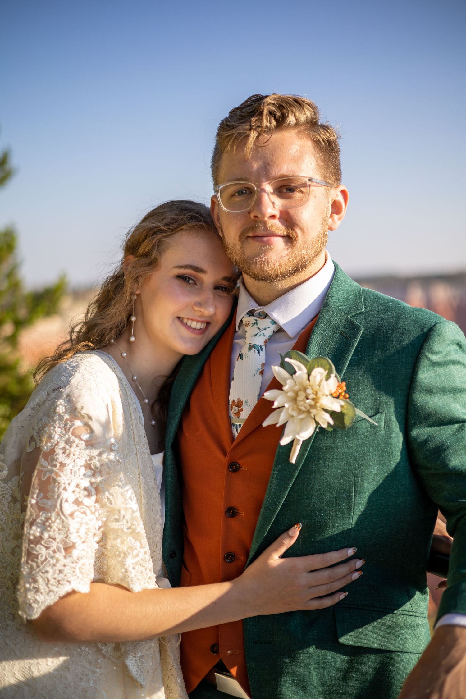 Wedding couple shares loving moments together in front of scenic mountain views.