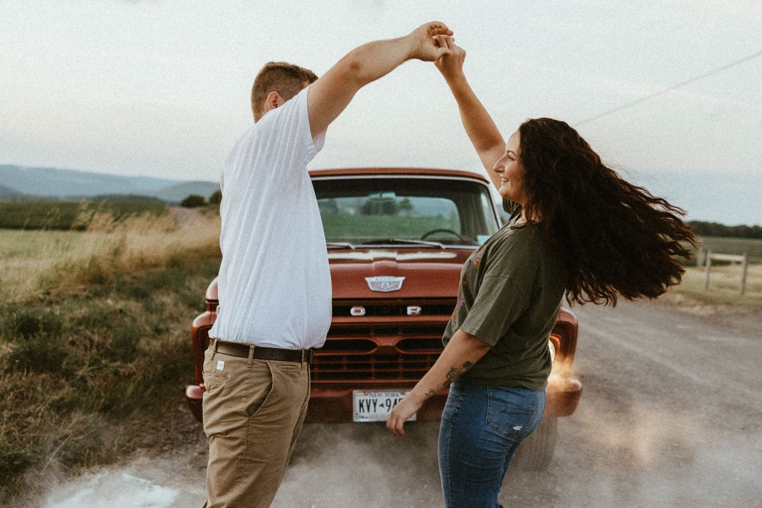 a couple dancing on a dirt road in the finger lakes