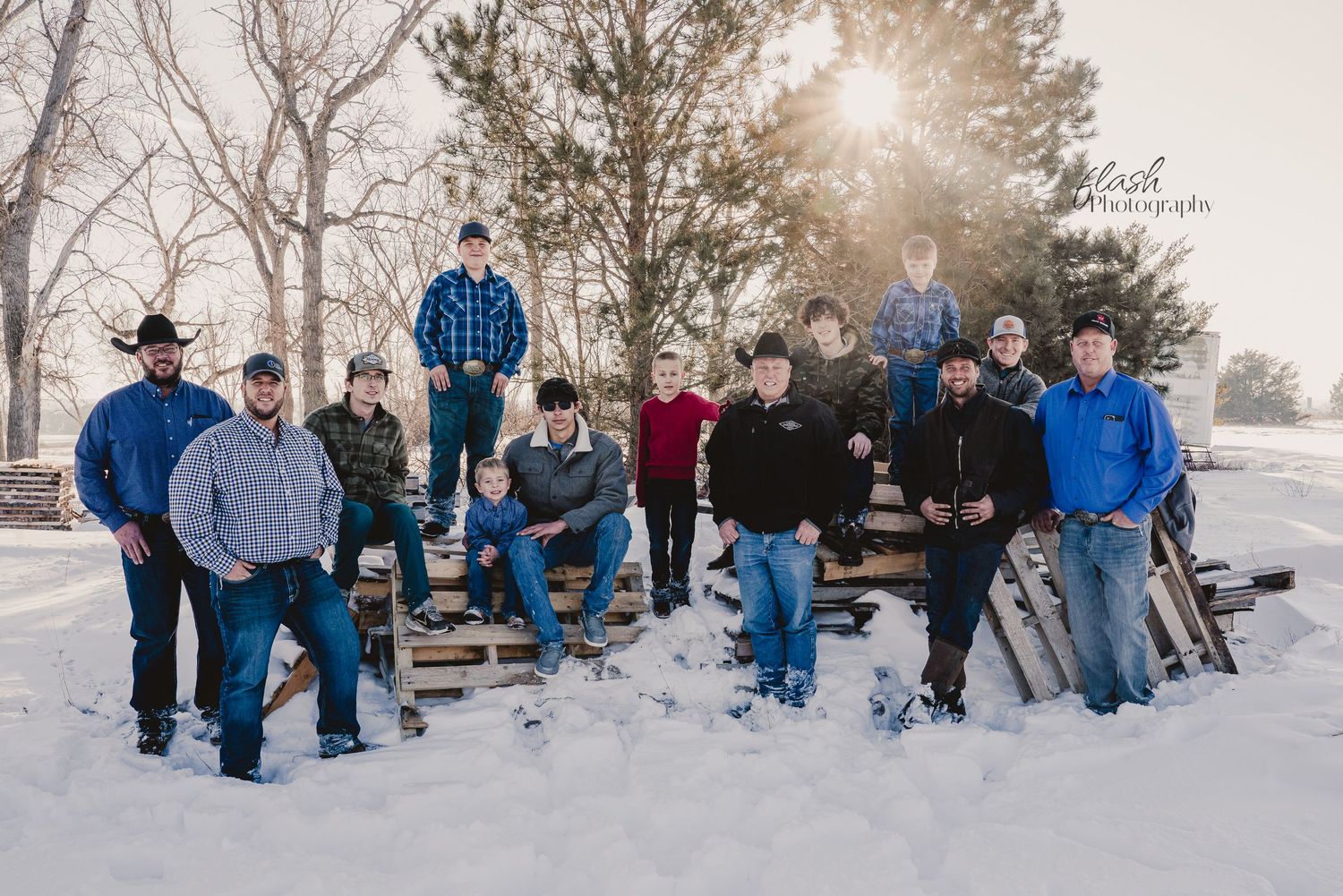 Large group photo of people posing in snow covered landscape during winter.