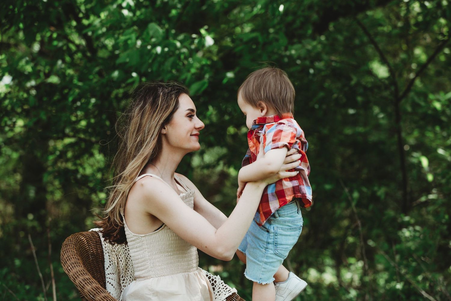 Candid family moments captured in lush green outdoor setting.
