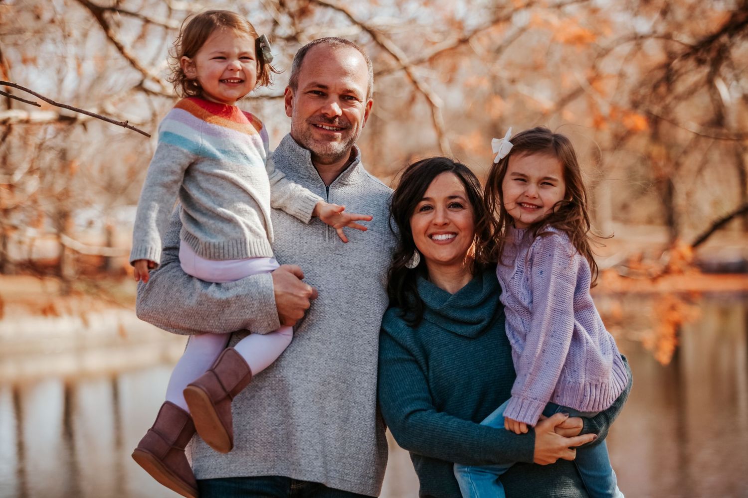 Casual family portraits in autumn setting with coordinated casual wear.
